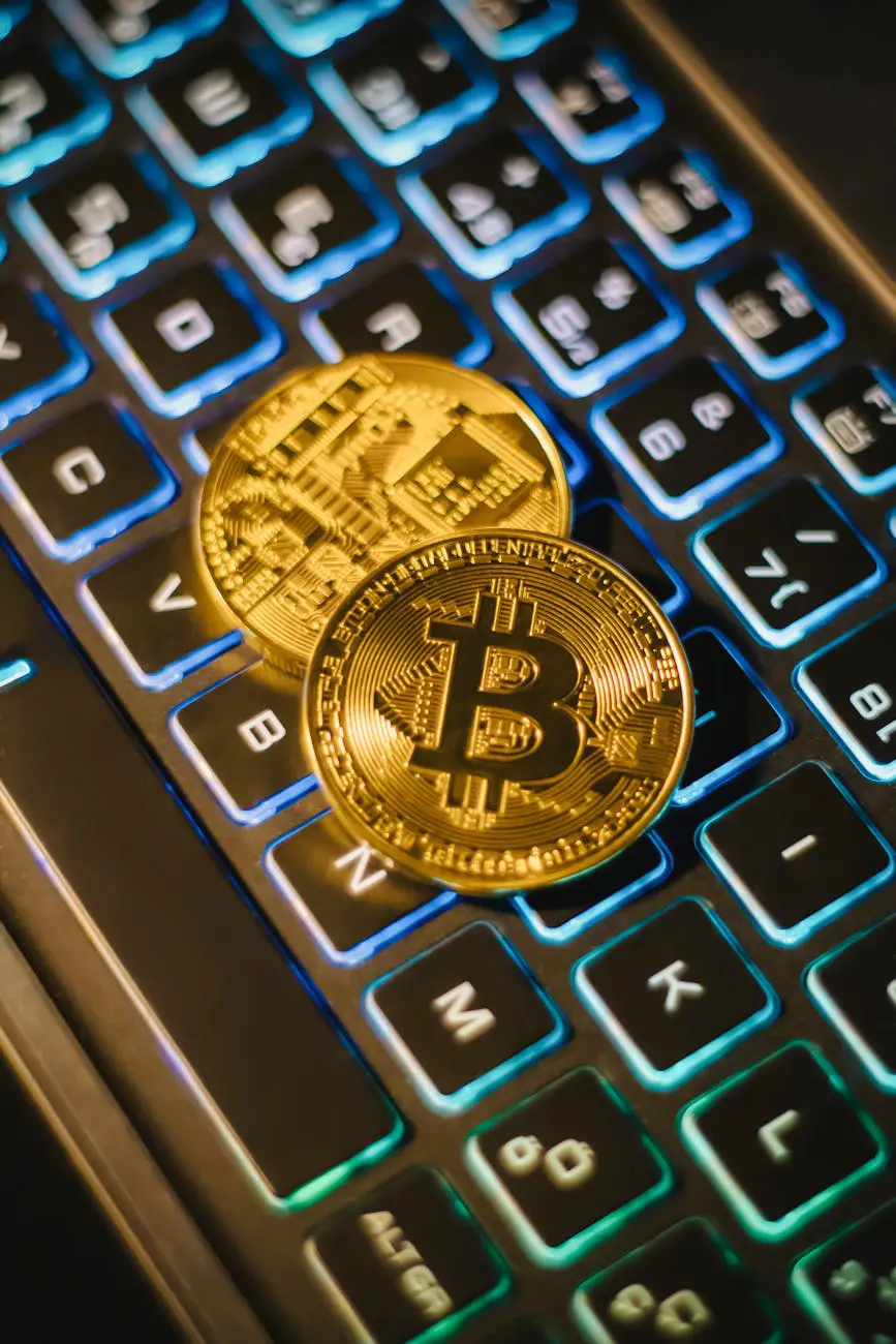 Bitcoin coins on illuminated keyboard representing blockchain and digital technology