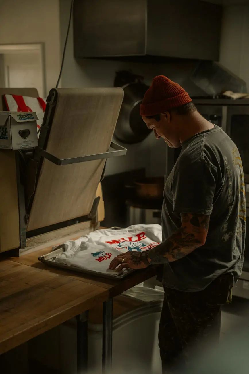 A person preparing a t-shirt for printing in a workshop - Print on Demand business model