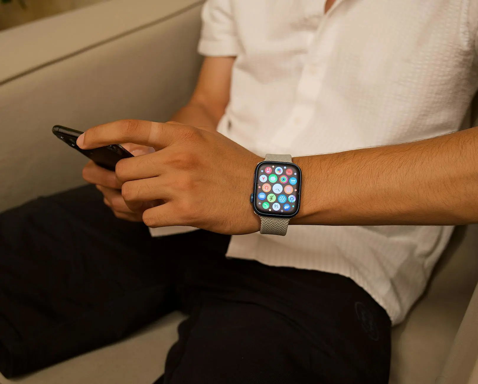 Person wearing smartwatch displaying WearOS application interface