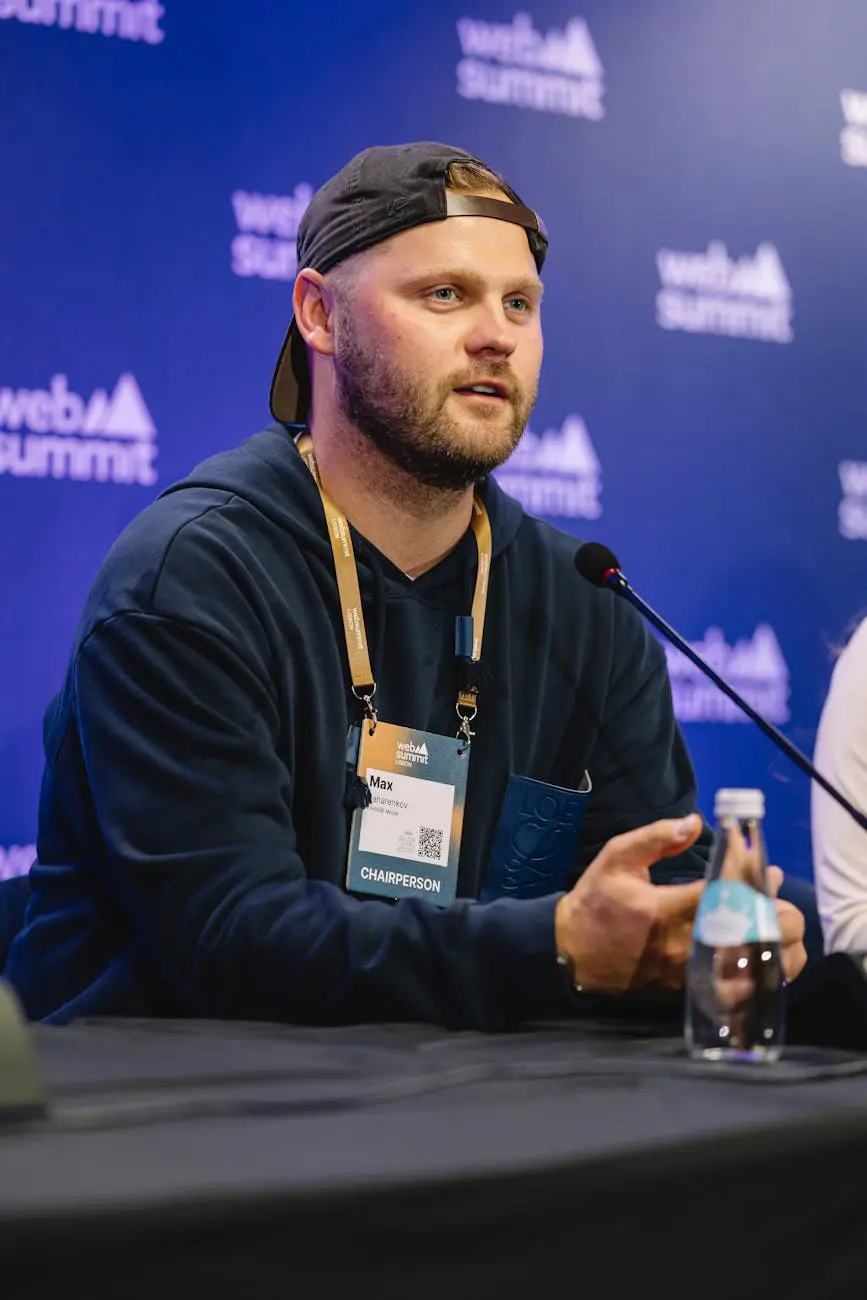 Speaker presenting at a tech conference to an engaged audience