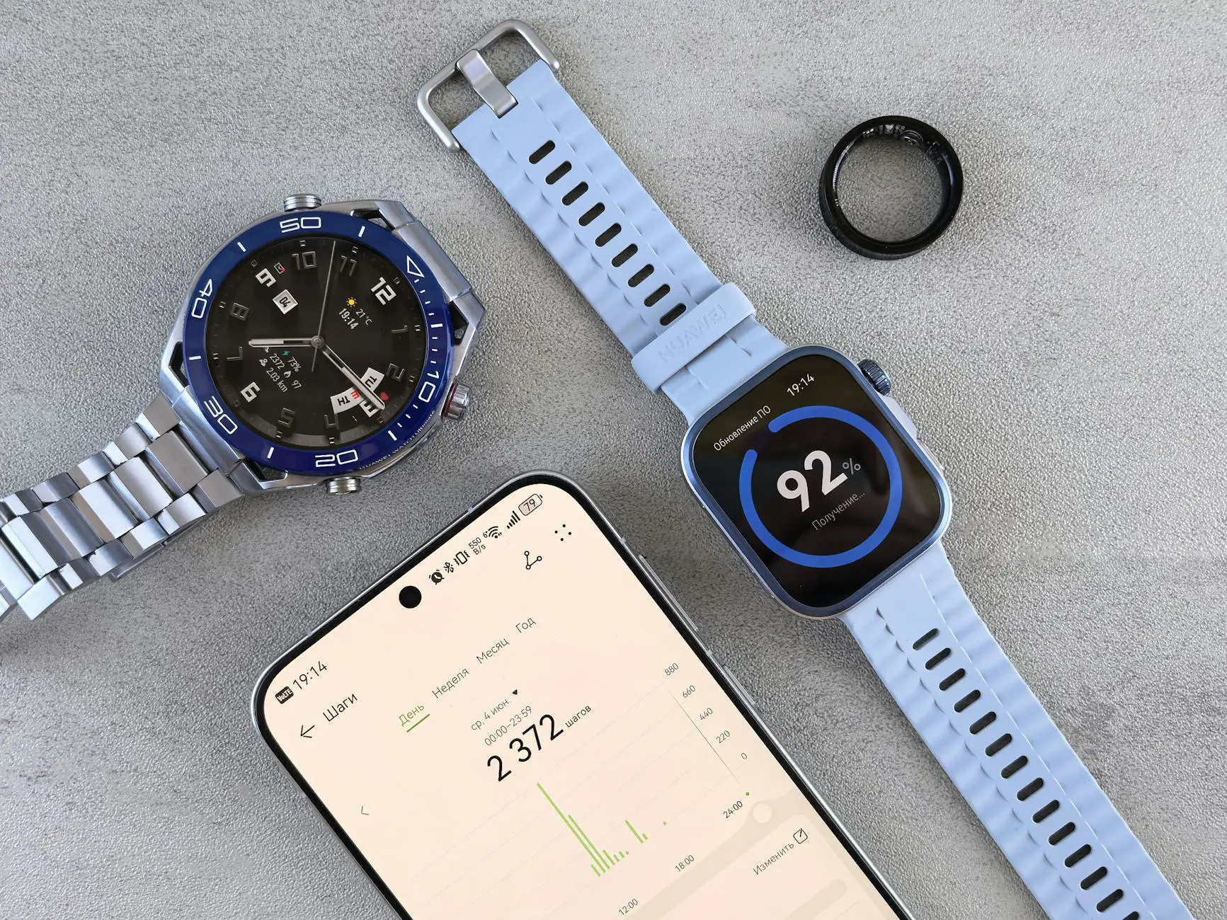 Smartwatch, ring tracker, and smartphone displaying health and fitness data