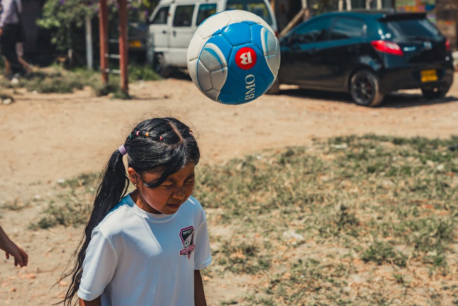 Genç Kız Dışarıda Bir Futbol Topuna Kafa Atıyor